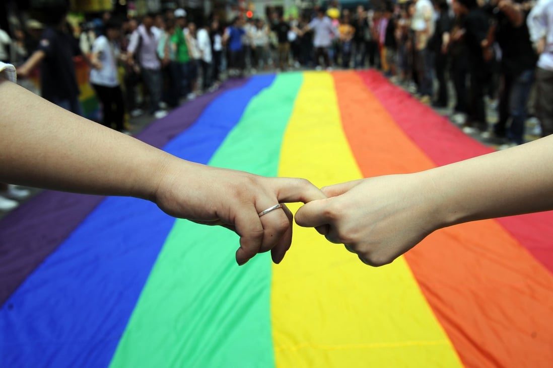 LGBT activists in Hong Kong form a human chain around a rainbow flag during celebrations marking the fourth annual International Day Against Homophobia, in May 2008. The event was launched in 2005 to commemorate the day in 1990 when the World Health Organization removed homosexuality from its list of mental disorders. Photo: AFP