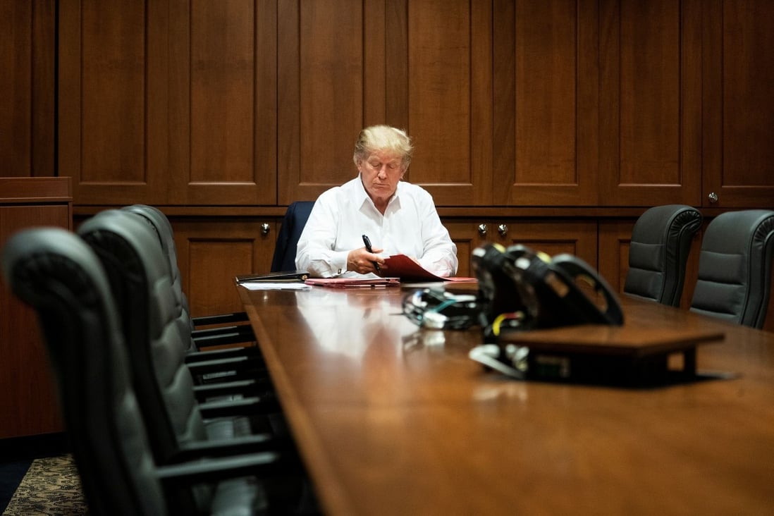 US President Donald Trump works in a conference room at Walter Reed National Military Medical Center while receiving treatment for Covid-19. Photo: Reuters