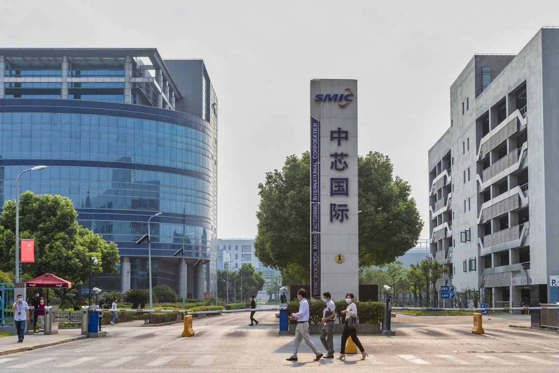 People walk in front of the main gate of chip foundry Semiconductor Manufacturing International Corp’s headquarters in Shanghai on September 7. Photo: EPA-EFE
