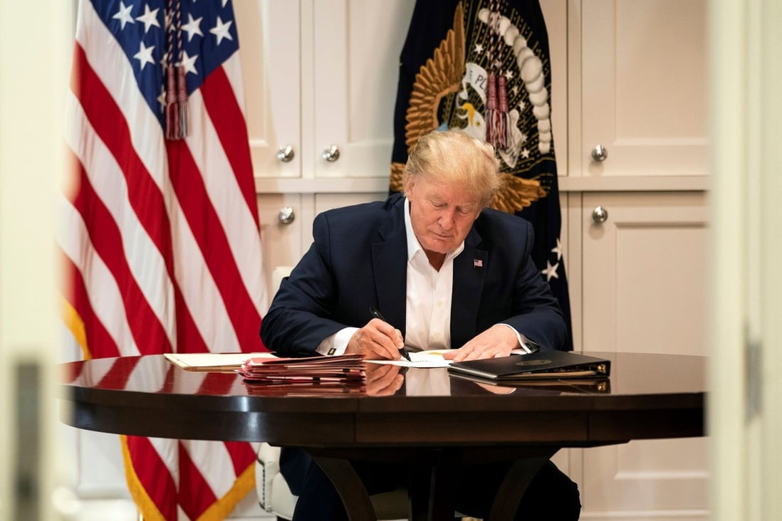 US President Donald Trump working in the presidential suite at Walter Reed National Military Medical Center in Bethesda, Maryland on Saturday, after testing positive for Covid-19. Photo: Joyce N. Boghosian/The White House via AFP