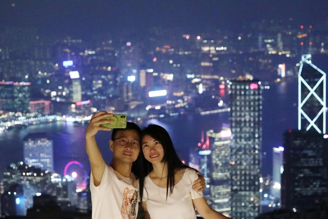 A couple takes a selfie at The Peak. Photo: SCMP / Felix Wong