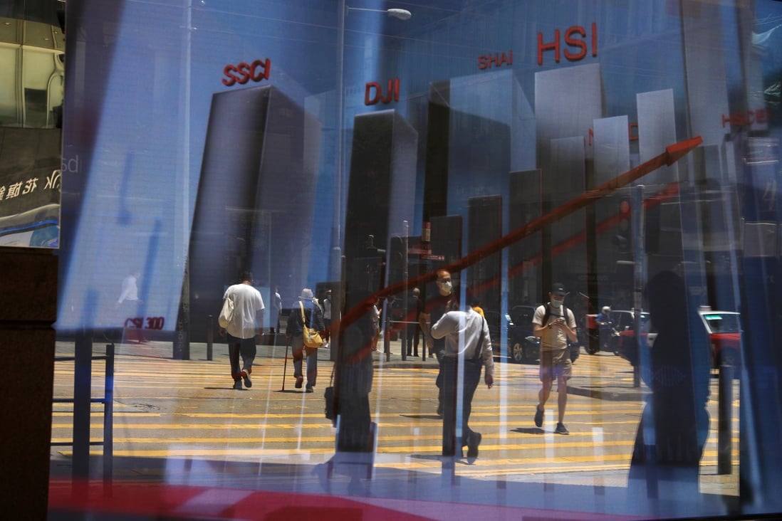 An electronic board showing the various stock market indices is seen in Central, Hong Kong. Photo: May Tse