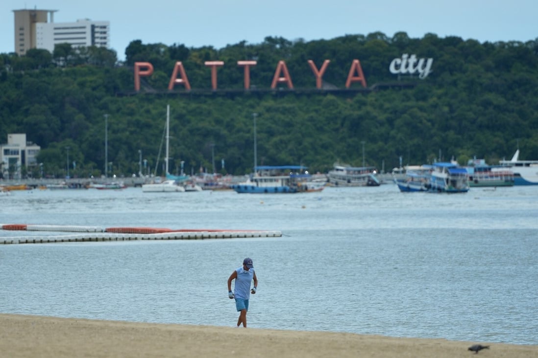 A man runs along the beach in Pattaya in Thailand’s Chonburi province. The resort city is reeling from a lack of tourists due to Covid-19 travel restrictions. Photo: Xinhua
