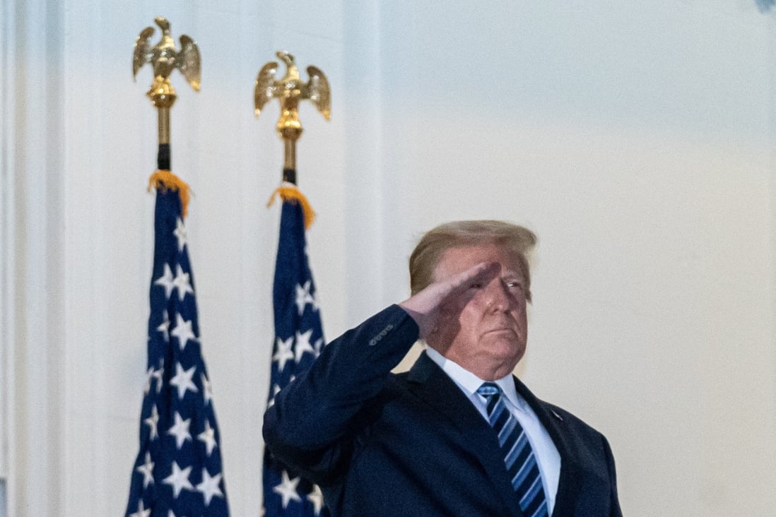 US President Donald Trump salutes after taking off his mask on returning to the White House. Photo: EPA-EFE