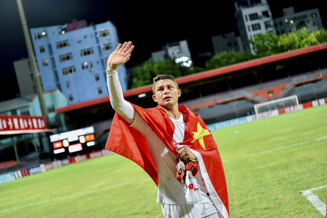 China's Brazilian-born forward Elkeson, known as Ai Kesen in Chinese, celebrates with a Chinese national flag after a Fifa World Cup Qatar qualifying win over Maldives. Photo: AFP