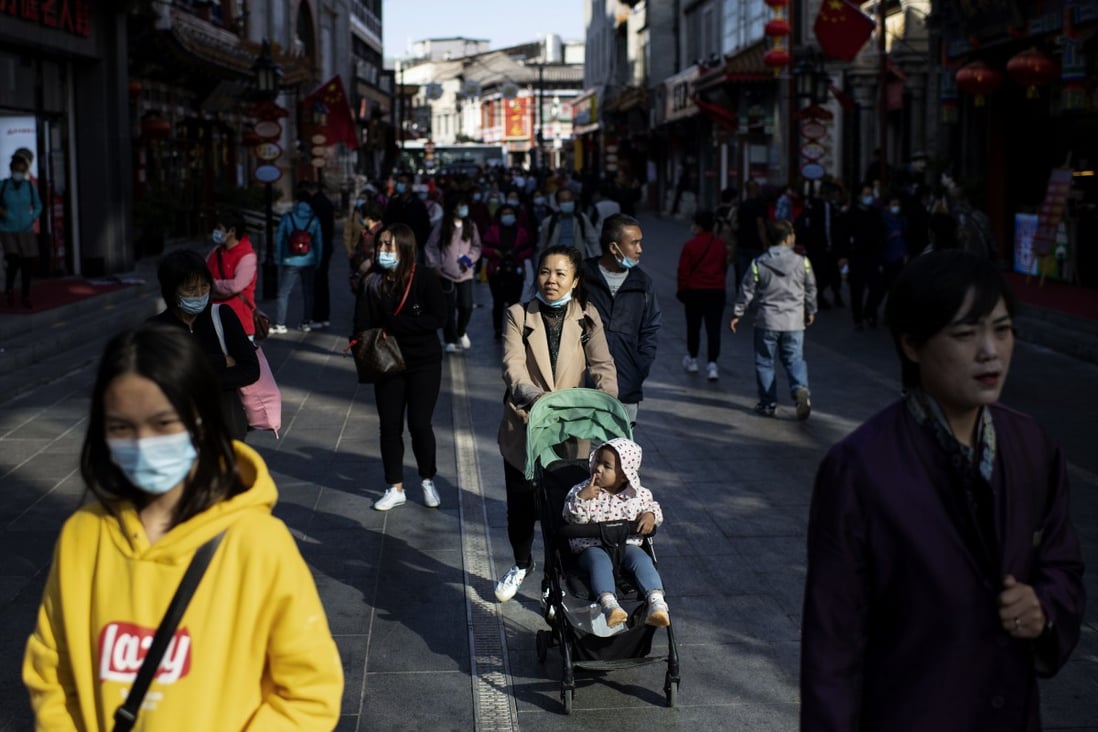 People walk along Qianmen Street in Beijing on October 5 during China’s “golden week” holiday. Photo: AFP