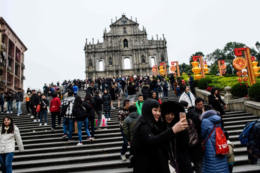 Tourists throng the southern facade of the ruins of St Paul’s Church in Macau in February 2018. The Portuguese presence in Asia is one of the longest from the Western countries, spanning over five centuries. It became the last to leave the continent with the consensual return of the sovereignty of Macau in 1999. Photo: AFP