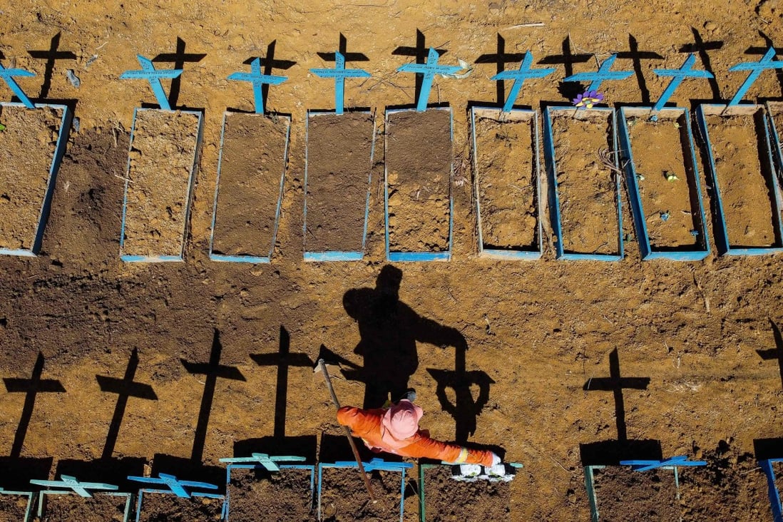 A gravedigger stands at the Nossa Senhora Aparecida cemetery where Covid-19 victims are buried daily, in Manaus, Brazil in June. Photo: AFP