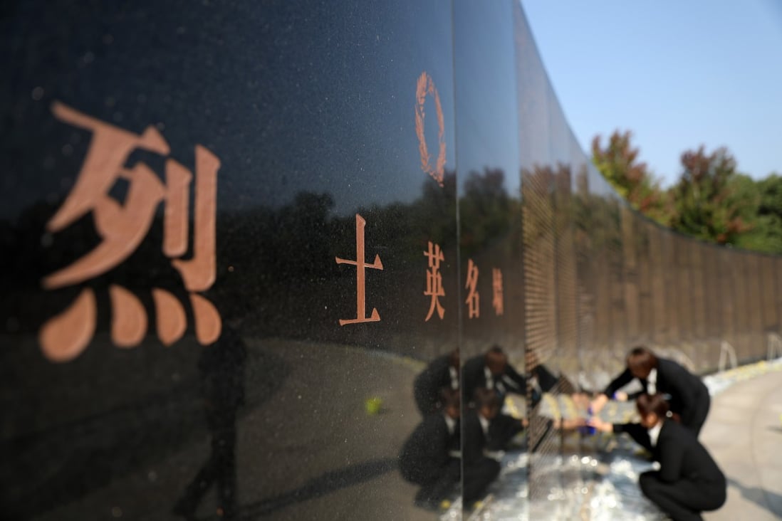Cemetery staff members wipe down a memorial wall engraved with the names of the Chinese People’s Volunteer soldiers killed in the Korean war, at a cemetery in Shenyang, Liaoning province, on September 27. Photo: Xinhua