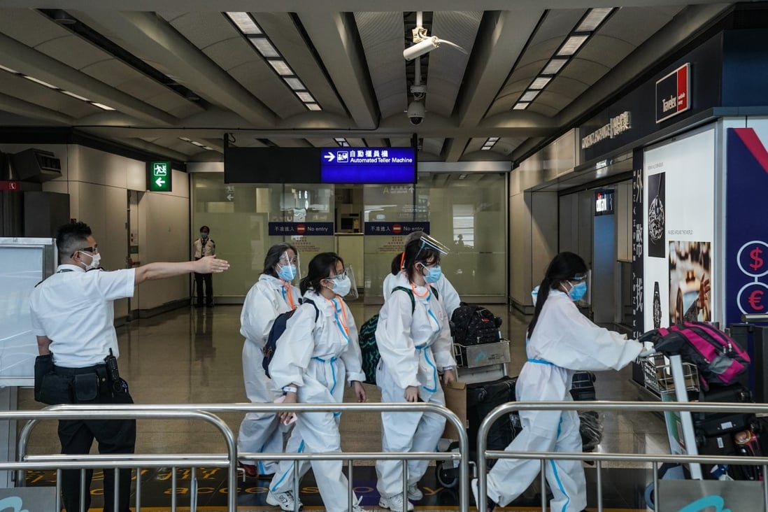 An official directs travellers towards a quarantine area in the arrivals hall of Hong Kong airport on July 15. Photo: Bloomberg