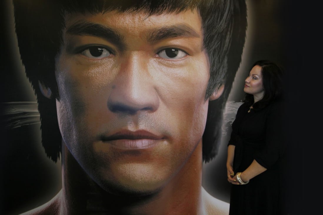 Shannon Lee in 2013 with a poster of her father, Bruce Lee, who she feels has been vindicated by Warrior, the series based on an idea he is said to have pitched to Warner Bros. Photo: AP