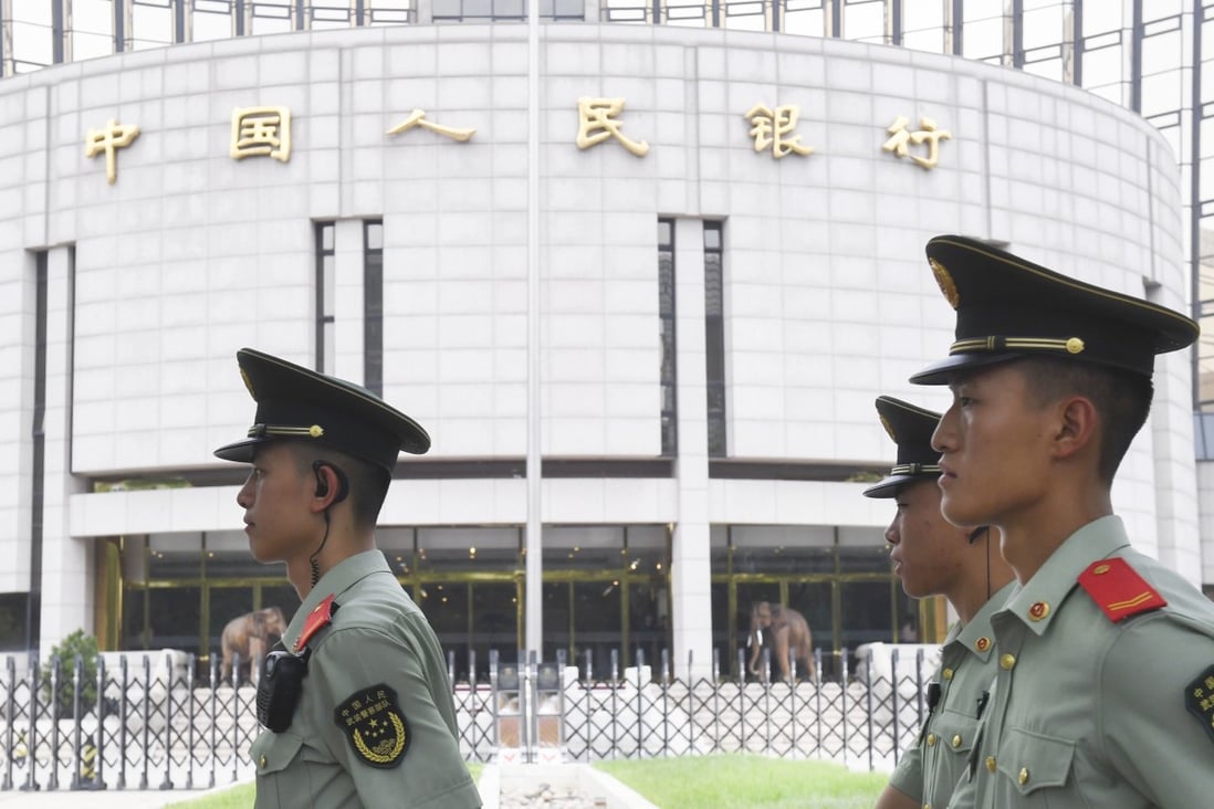 Secuity officers patrolling outside China’s central bank in Beijing. Photo: Kyodo