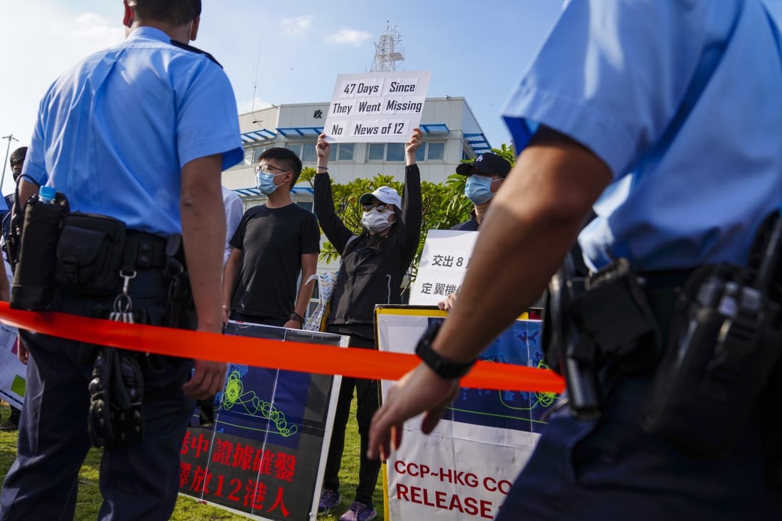 Campaigners for the 12 fugitives detained in Shenzhen, who include their relatives, demonstrate outside the Government Flying Service headquarters on Lantau Island. Photo: Sam Tsang