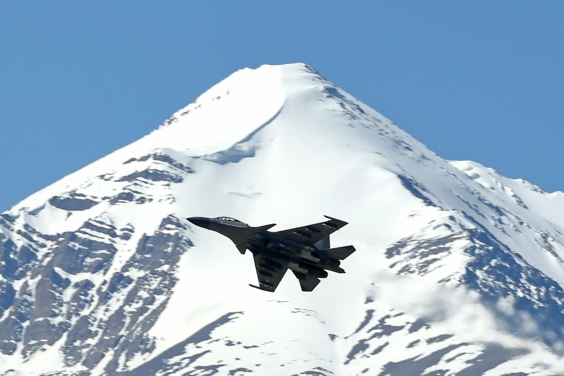 An Indian fighter jet flies over a mountain range near the China-India border in June. Photo: AFP