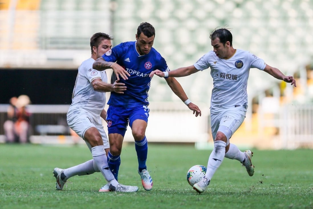 Eastern's Lucas tries to escape the attentions of his R&F rivals in the Hong Kong Premier League title decider at Hong Kong Stadium. Photo: HKFA