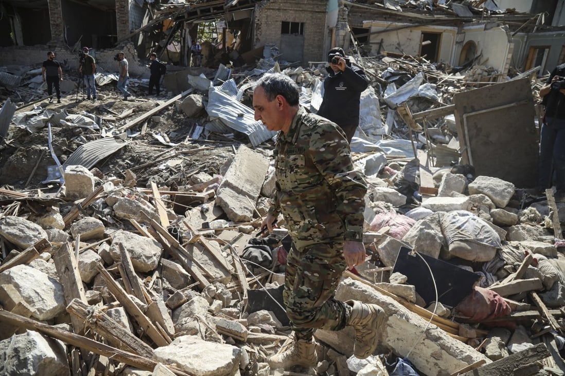 Rescuers look through the rubble of houses damaged by recent shelling in Ganja, Azerbaijan, October 11. Photo: EPA-EFE