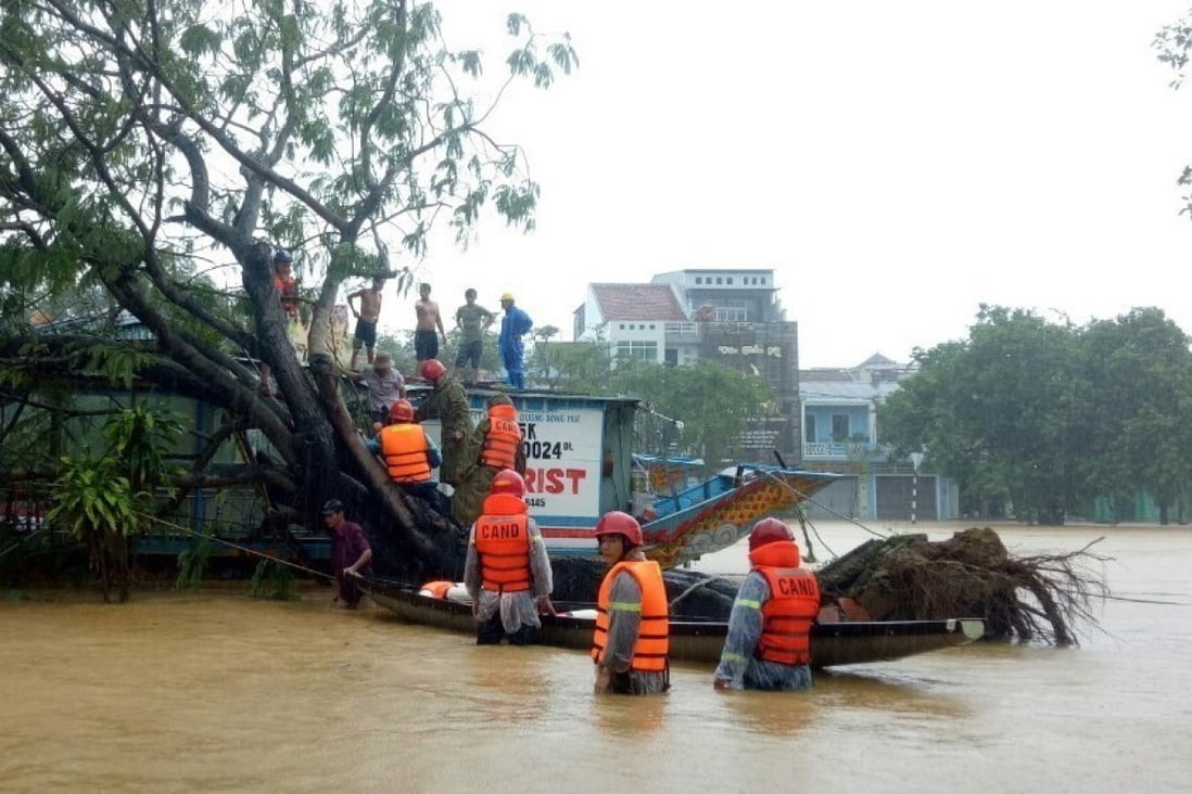 Officials evacuate residents from Hue, Vietnam after heavy rains caused flooding. Photo: EPA