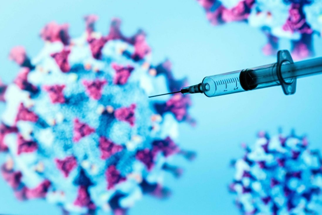 A syringe is pictured on an illustration representing the coronavirus that causes Covid-19. Photo: AFP