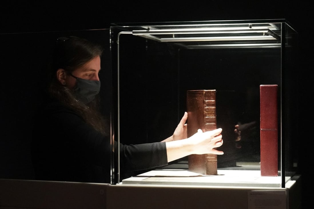 A Christie's employee holds a rare first folio of 36 Shakespeare works in New York on Wednesday. Photo: Reuters