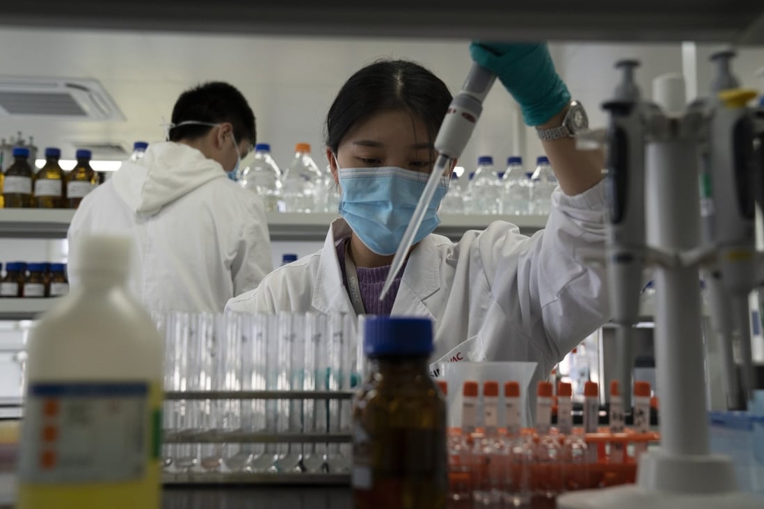 A SinoVac lab employee works at a factory producing its Sars-CoV-2 vaccine in Beijing on September 24. Plans to rely on herd immunity to contain the spread of Covid-19 would require more than 5 billion people worldwide to have had the infection before it would take effect. Photo: AP