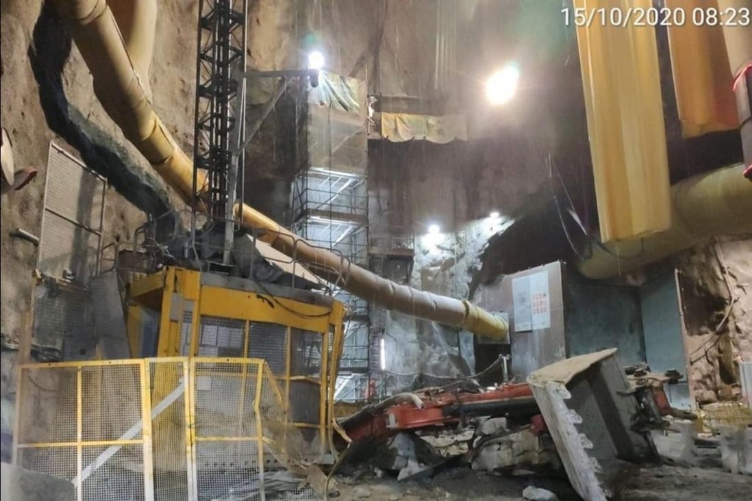 An excavator lies at the bottom of a deep shaft after breaking free from the crane that was lowering it at a Hong Kong highway construction site. Photo: Handout