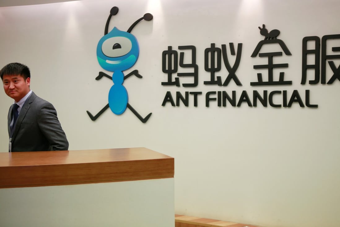 An employee stands next to the logo of Ant Financial Services Group, Alibaba's financial affiliate, at its office in Hangzhou in January 2018. Photo: Reuters