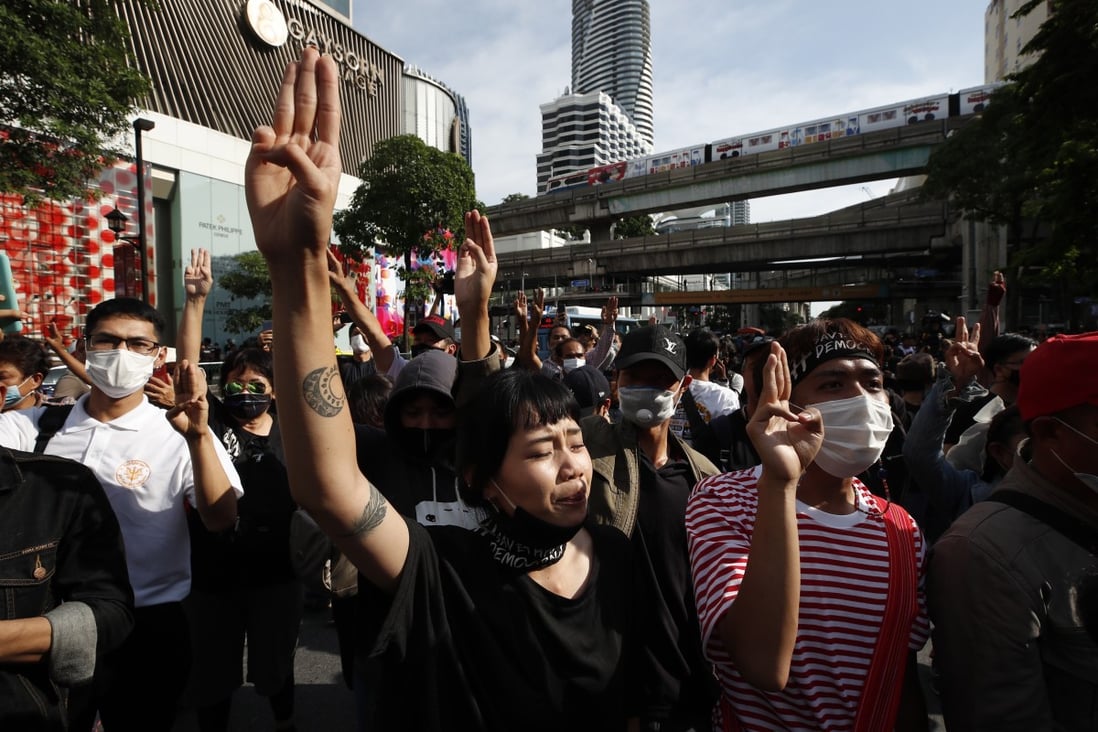 Pro-democracy protesters flash the three-finger salute during a rally against the state of emergency. Photo: EPA