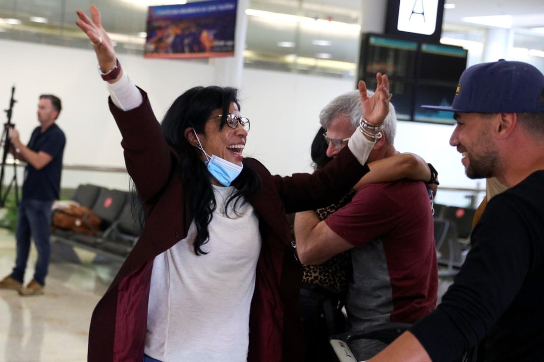 A woman is greeted by a friend as she arrives from New Zealand after the Trans-Tasman travel bubble opened overnight, following an extended border closure due to the Covid-19 pandemic. Photo: Reuters