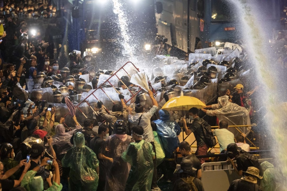 Pro-democracy demonstrators face water canons as police try to disperse them from their protest venue in Bangkok on Friday. Photo: AP