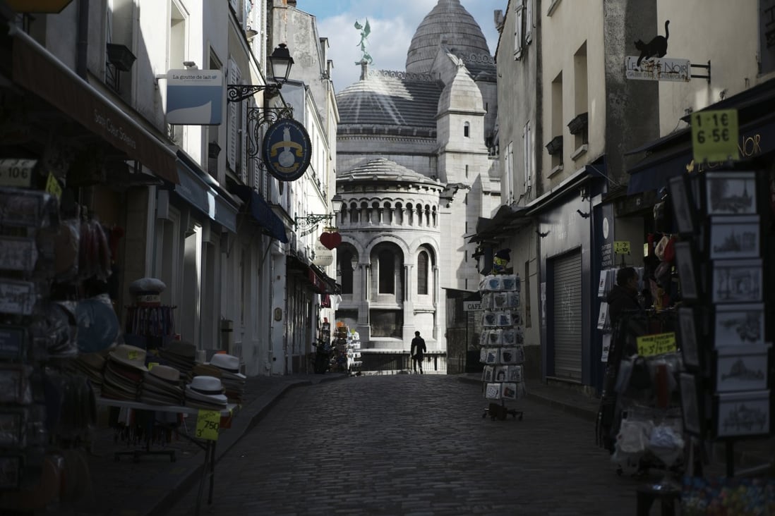 Tourists shops are empty in a deserted street outside the Sacre Coeur basilica in the Montmartre district of Paris. Photo: AP