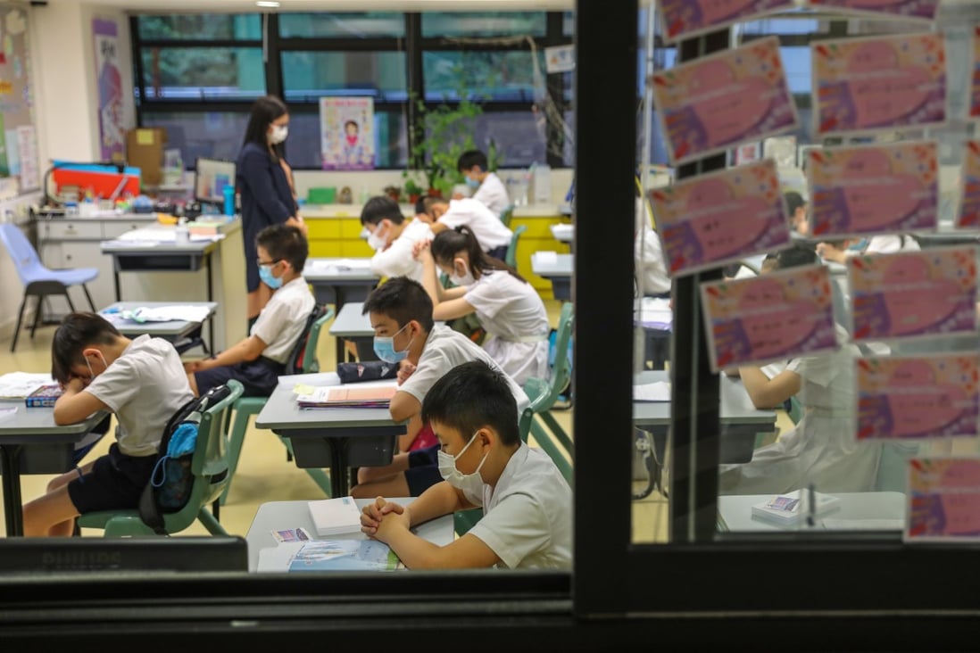 Students at a primary school in Wan Chai pray for the coronavirus situation in Hong Kong to ease, after classes resumed briefly in June. Photo: Nora Tam