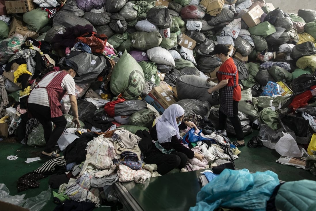 Employees sort used clothing at a facility operated by second-hand clothing trading firm Baijingyu in Hangzhou, China. Less than 1 per cent of the 26 million tonnes of clothing and accessories discarded each year in China is recycled or reused; the rest is exported, downcycled or burned. Photo: Bloomberg