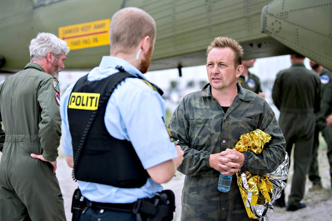 Peter Madsen in 2017, talking to a police officer in Dragoer Harbor south of Copenhagen. Photo: AFP