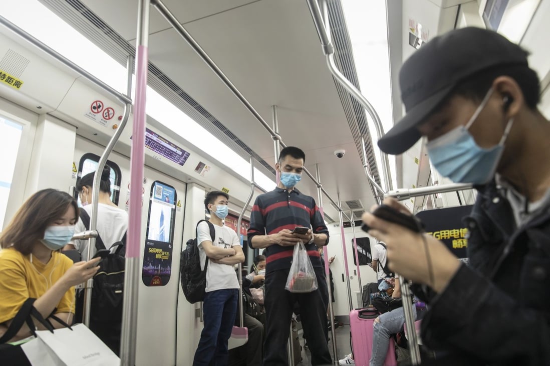 Passengers use smartphones while travelling on a subway train in Wuhan on May 1. Photo: Bloomberg