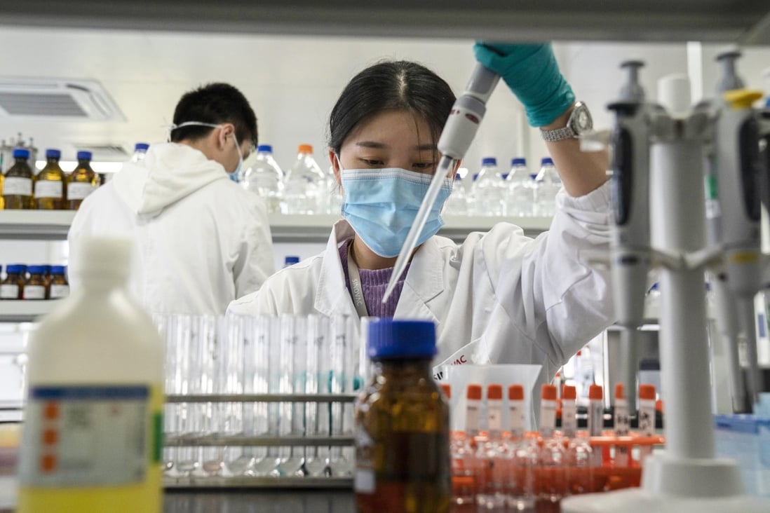 A Sinovac employee works in a lab at a factory producing CoronaVac, a vaccine against Covid-19, in Beijing. Photo: AP Photo