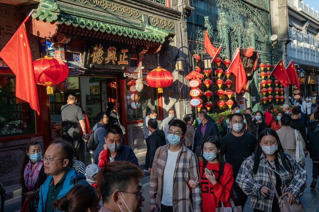 Pedestrians walk through the Qianmen area of Beijing on October 4, during the Golden Week holiday. China is the only major economy expected to post positive economic growth in 2020. Photo: Bloomberg