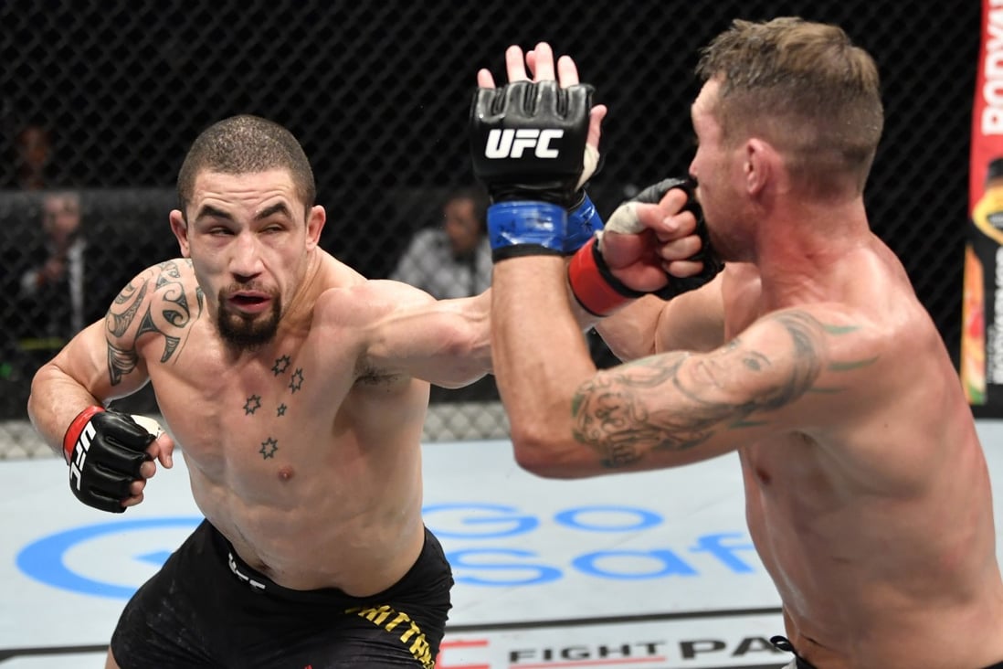 Robert Whittaker punches Darren Till in their middleweight fight during the UFC Fight Night event inside Flash Forum on UFC Fight Island. Photo: Jeff Bottari/Zuffa LLC via USA TODAY Sports