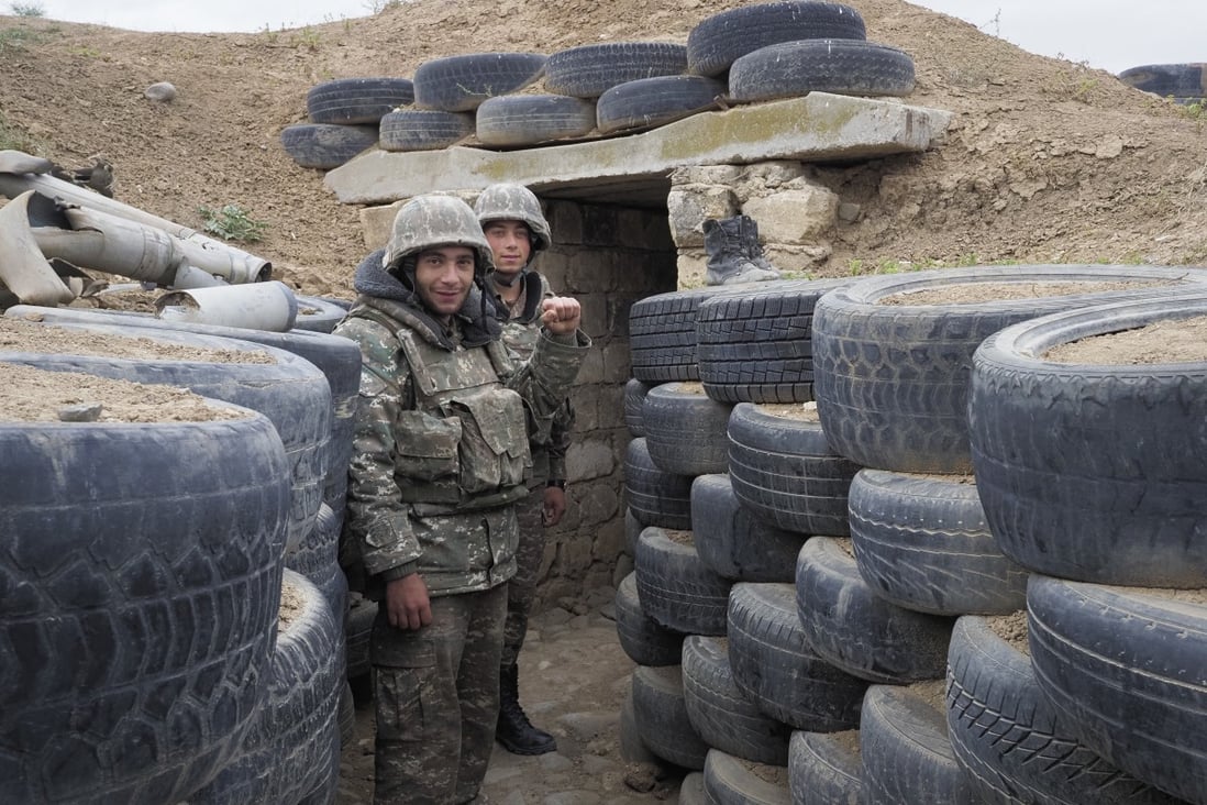 Ethnic Armenian soldiers stand guard in a frontline trench against Azerbaijan's armed forces. Photo: AP