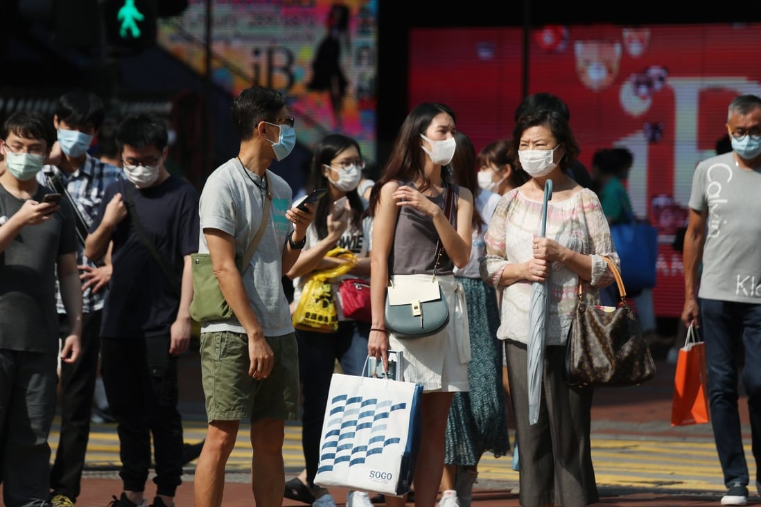 Pedestrians in masks cross the street in Causeway Bay. Photo: Xiaomei Chen