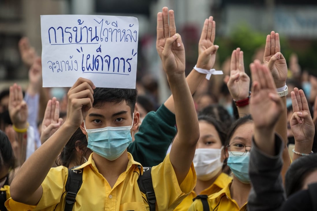 Pro-democracy protesters make the three-finger salute during an anti-government demonstration demanding the resignation of Thai Prime Minister Prayuth Chan-ocha. Photo: DPA