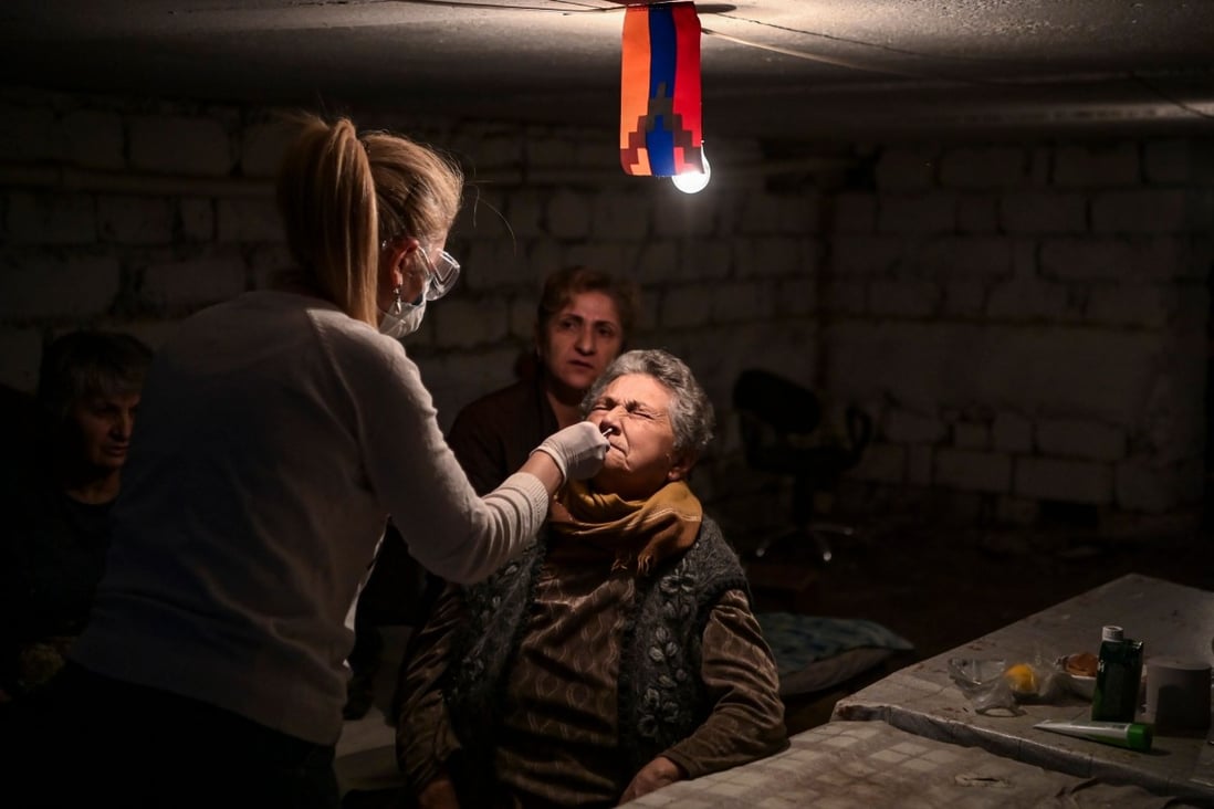A doctor swabs an elderly woman as she administers a Covid-19 test in the city of Stepanakert on Friday. Photo: AFP