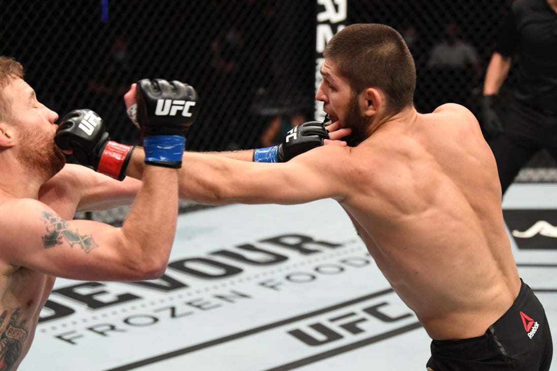 Khabib Nurmagomedov punches Justin Gaethje in their lightweight title bout at UFC 254. Photos: Josh Hedges/Zuffa LLC via Getty Images