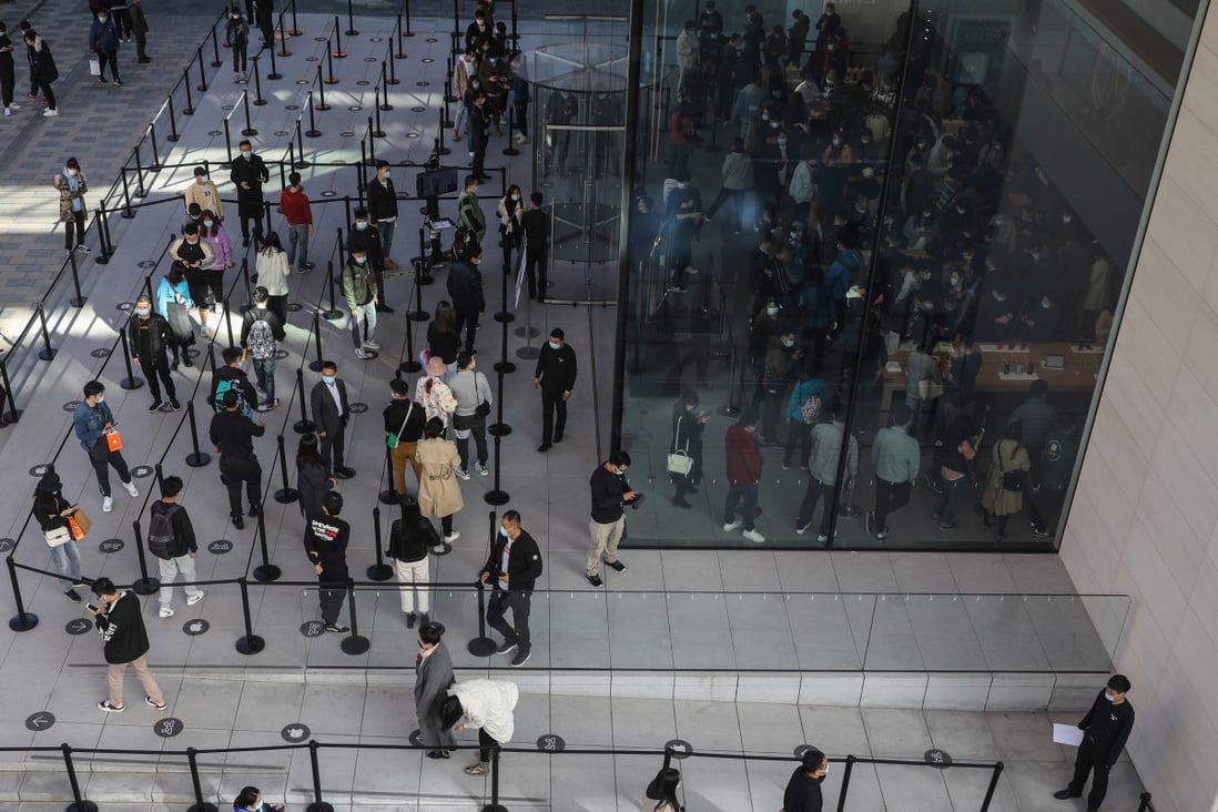 People line up to enter an Apple store in Beijing on October 23 as the sales begin for the new iPhone 12 and iPhone 12 Pro. China’s economy is recovering and consumer demand is picking up. Photo: EPA-EFE