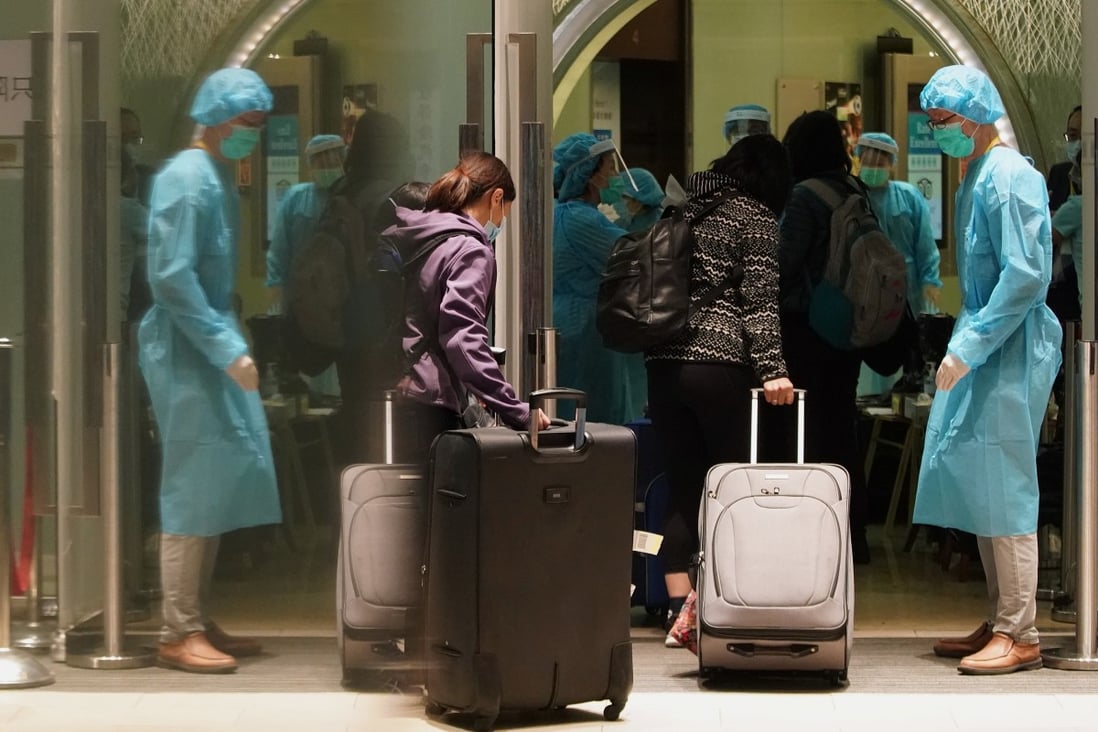 Hong Kong residents returning from overseas enter Regal Oriental Hotel in Kowloon City on April 22. The hotel was converted into a quarantine centre for Hongkongers waiting for the results of their coronavirus tests taken at the airport. Photo: Felix Wong