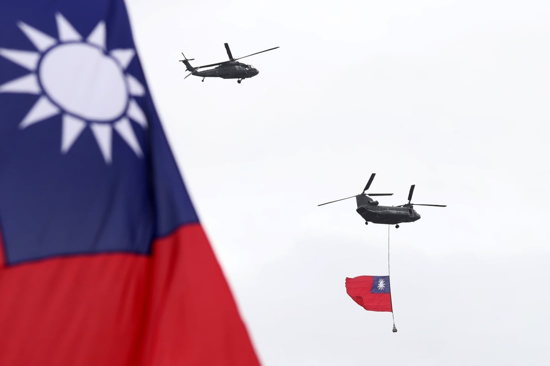 Military helicopters fly Taiwan’s flag over the President’s Office during National Day celebrations in Taipei on October 10. Photo: AP
