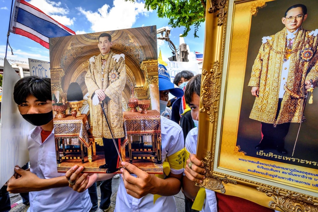 Demonstrators hold portraits of Thailand’s King Maha Vajiralongkorn (left) and his late father, king Bhumibol Adulyadej, during a rally demanding the protection of traditional Thai values, in Bangkok on July 30. Photo: AFP