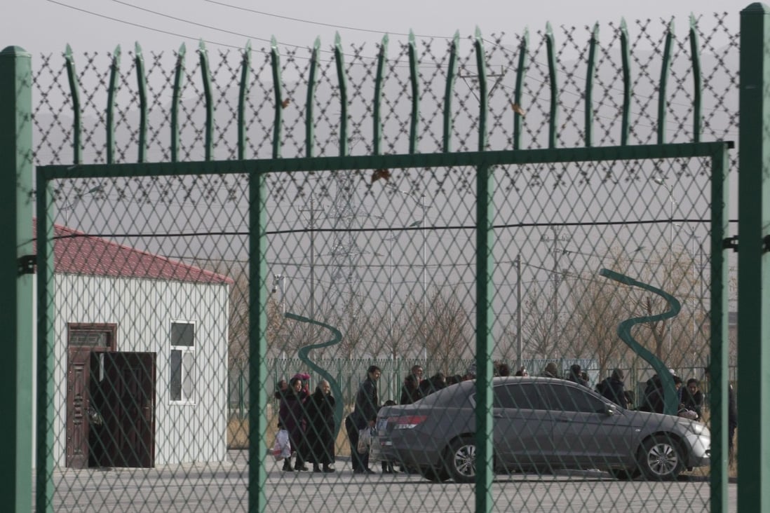 Residents line up inside the Artux City Vocational Skills Education Training Service Centre in Xinjiang. Leaked documents show it to be a forced indoctrination camp. Photo: AP