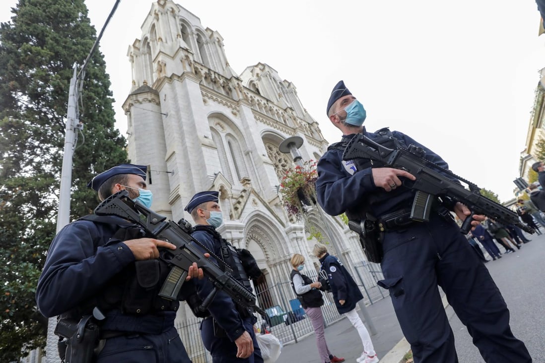 Police officers stand guard by the Notre-Dame basilica in Nice. Photo: AFP