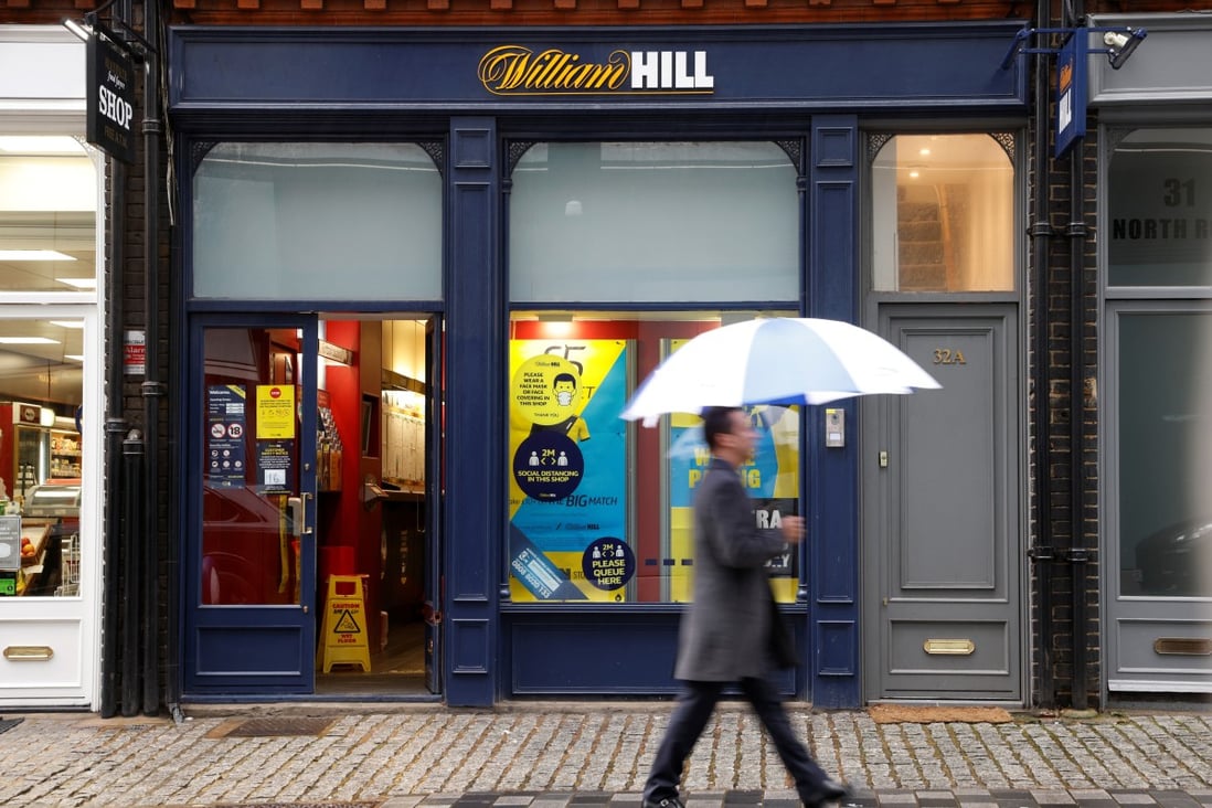 A man walks past a branch of bookmaker William Hill in London. Photo: Reuters