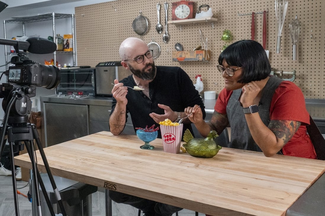 Andrew Rea, founder of the Binging with Babish network, tastes popcorn ice cream created by chef Sohla El-Waylly. Photo: AP/Mary Altaffer